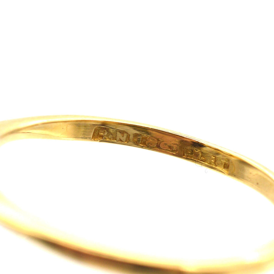 Close-up of the interior engraving of an Art Deco 18ct gold and platinum diamond cluster ring.