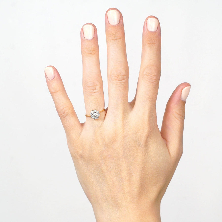 Hand wearing an Art Deco 18ct Gold & Platinum diamond cluster ring with millegrain setting.