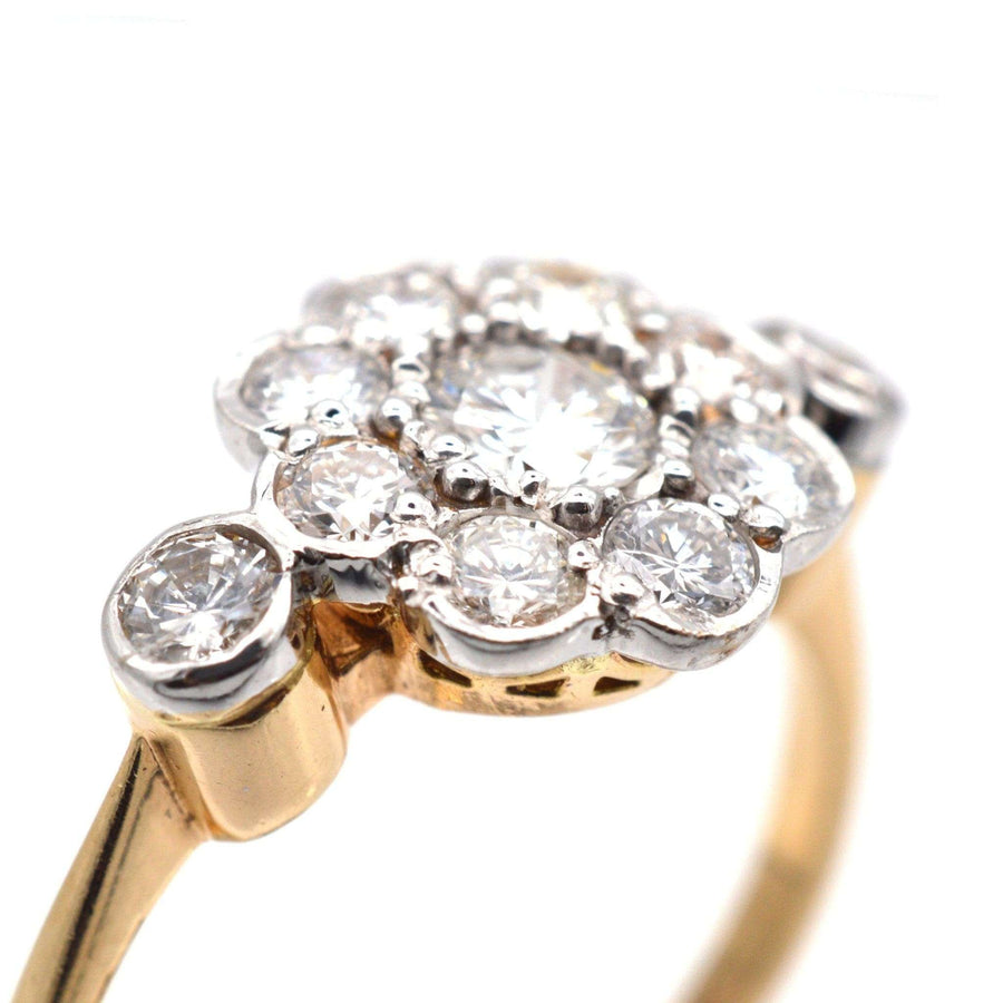 Art Deco 18ct gold and platinum diamond cluster ring featuring eight smaller diamonds surrounding a central stone.