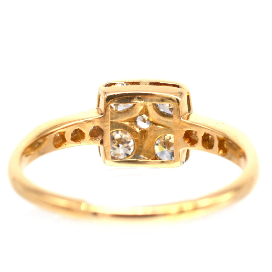 Art Deco 18ct gold and platinum diamond square ring featuring four diamonds and intricate shoulder detailing.