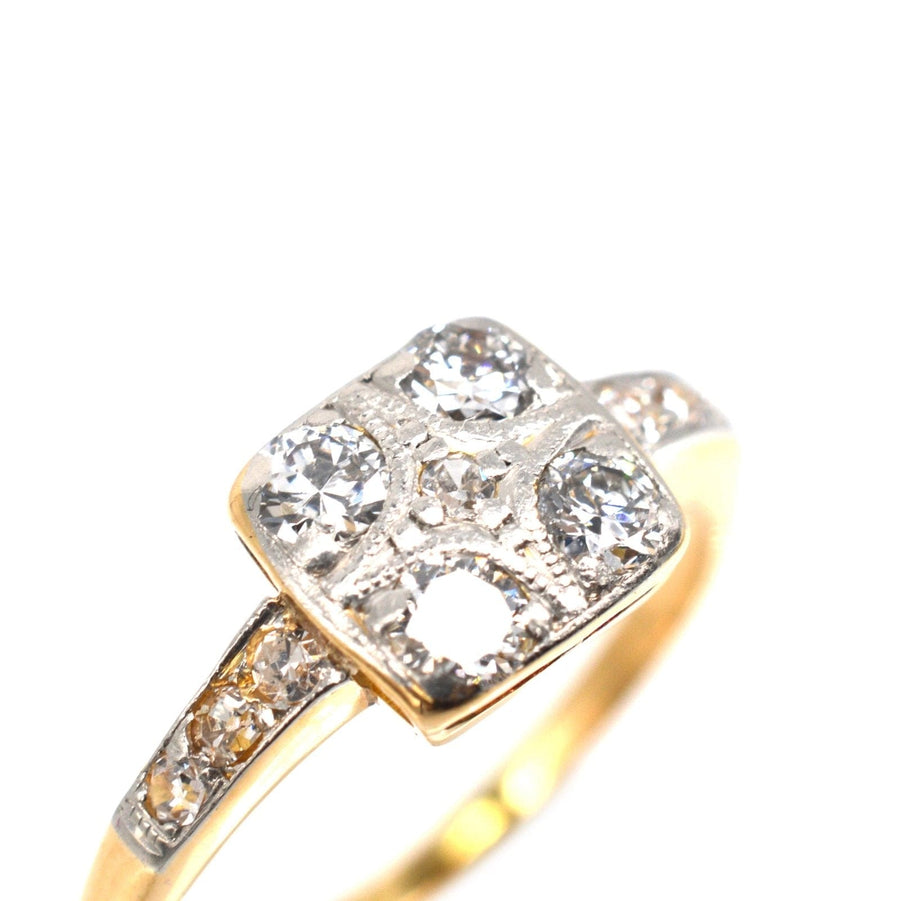 Art Deco 18ct gold and platinum diamond square ring featuring four diamonds and intricate shoulder details.