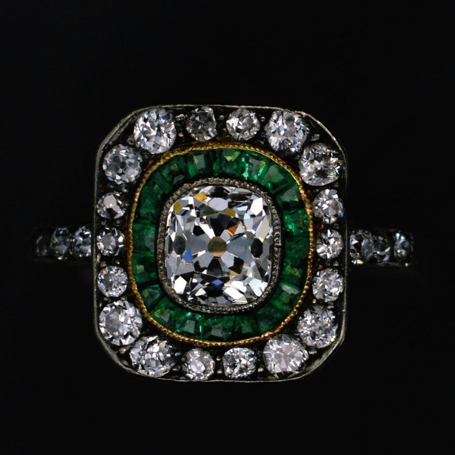 Art Deco 18ct gold and platinum target ring featuring old mine cut diamond, emeralds, and diamonds, circa 1925.