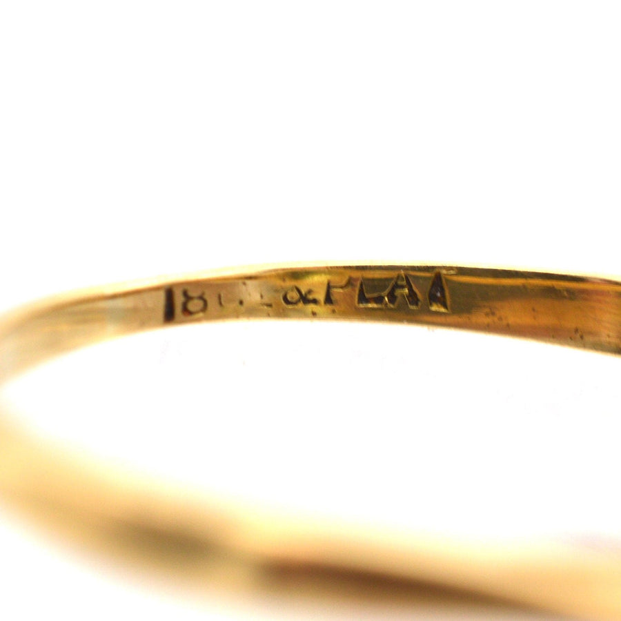 Close-up of 18ct gold stamp on a ring, showcasing fine craftsmanship and quality assurance.