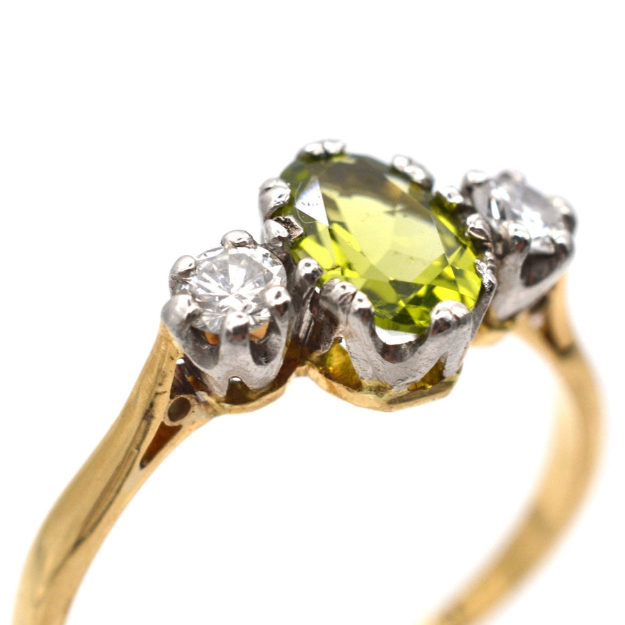 Art Deco 18ct gold and platinum three stone peridot and diamond ring with olive green peridot and sparkling diamonds.
