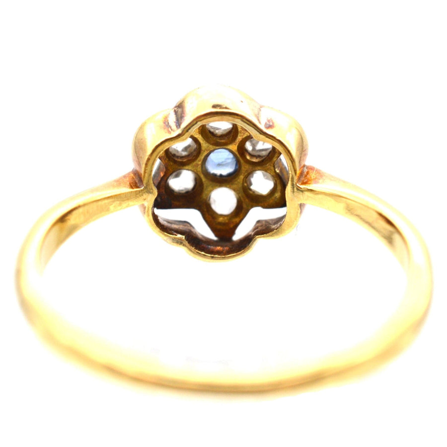 Art Deco 18ct & Platinum ring featuring flower-shaped design with rose cut diamonds and sapphire centerpiece.