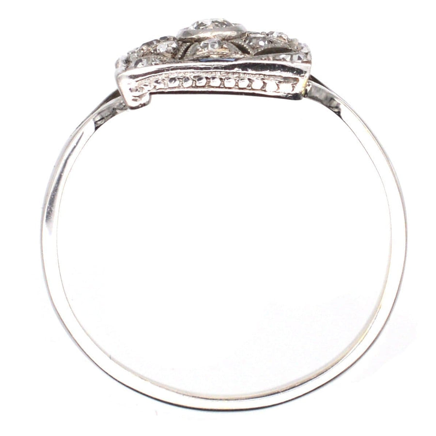 Art Deco 18ct white gold and platinum ring with diamond and sapphire plaque, showcasing a bold geometric design.