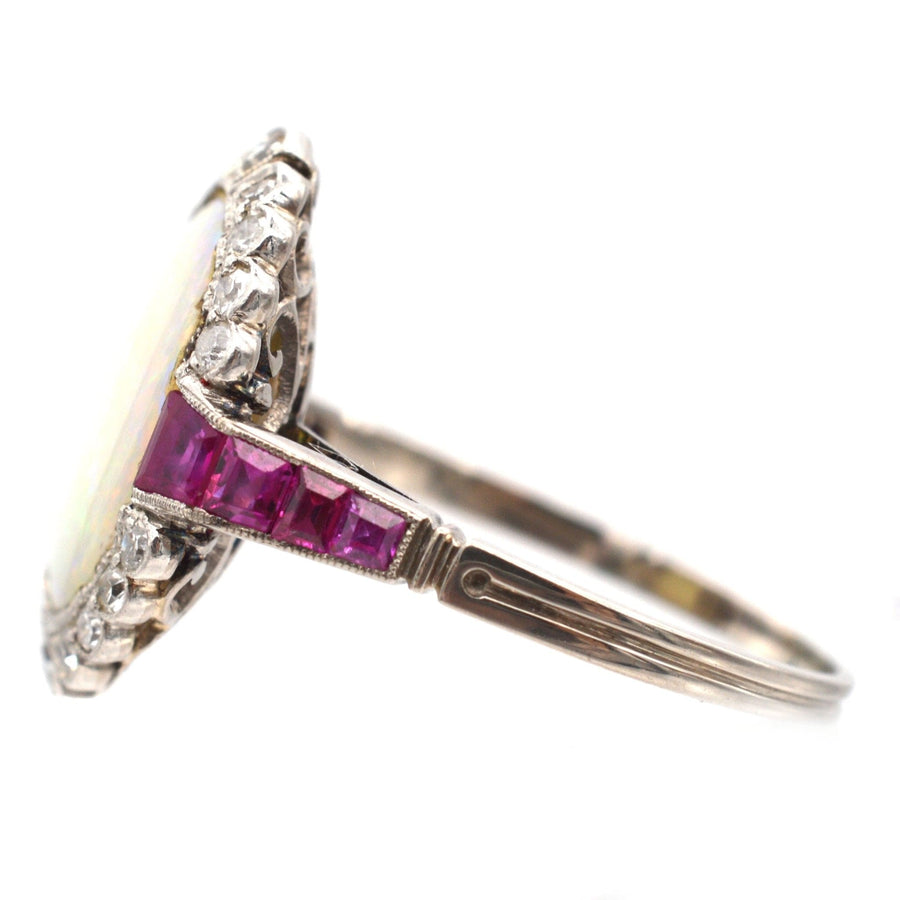 Art Deco 18ct white gold and platinum ring featuring opal, Burma rubies, and diamonds in stunning detail.