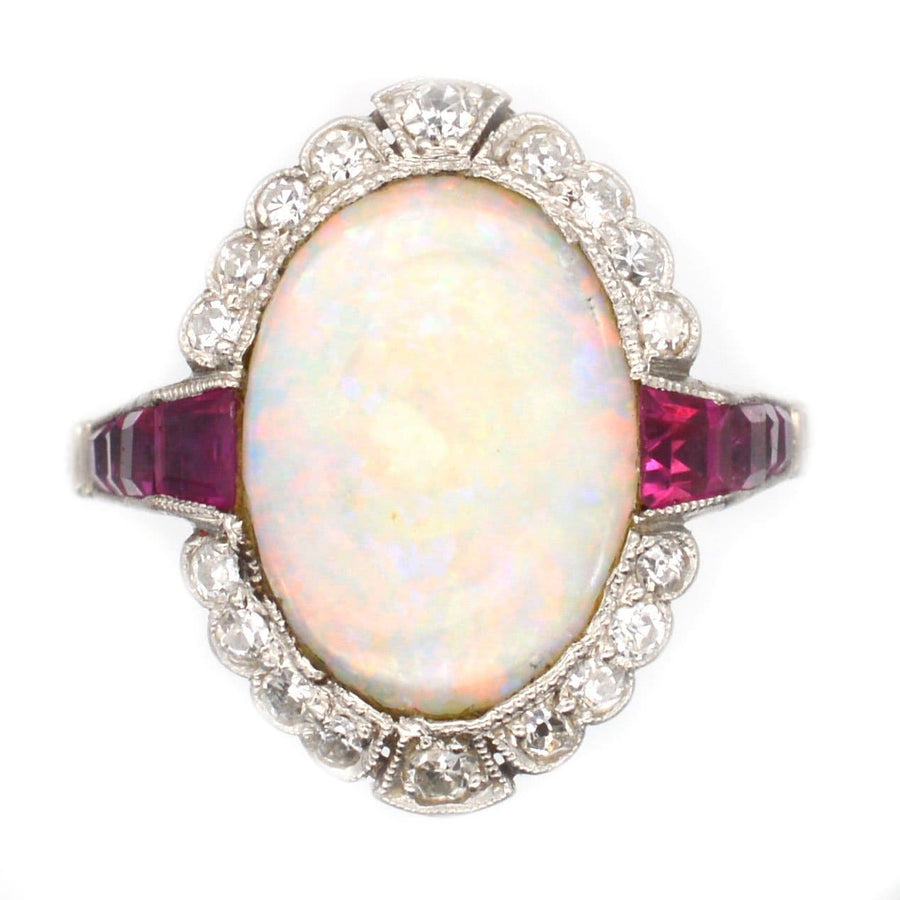 Art Deco 18ct white gold and platinum ring featuring an opal, Burma rubies, and diamonds in a stunning design.