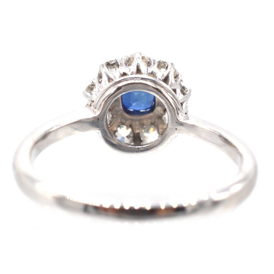Art Deco 18ct white gold ring featuring a central blue sapphire and surrounding diamonds, perfect for an engagement.
