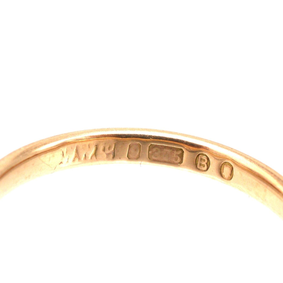 Close-up of the stamp on a 1937 9ct gold wedding ring, showcasing authenticity and craftsmanship.