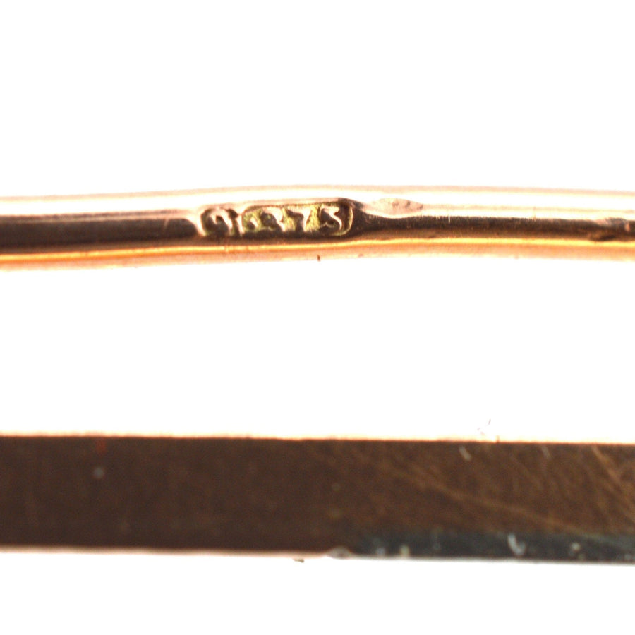 Close-up of the stamp on a 9ct gold and platinum bar brooch, showcasing its craftsmanship and authenticity.