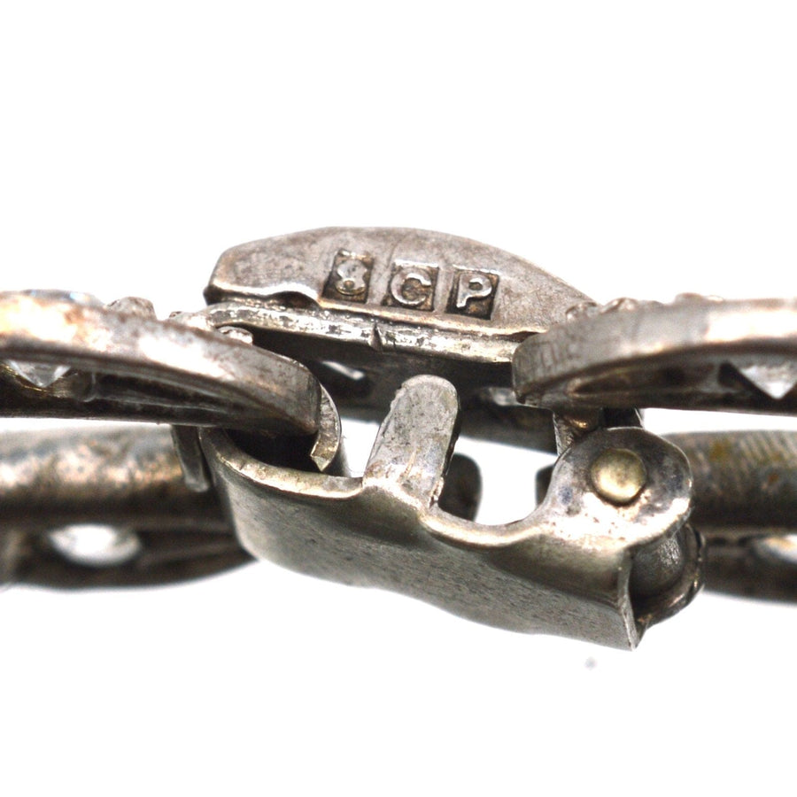 Close-up of Art Deco Ciro silver bracelet clasp showing SCP England stamp for authenticity.