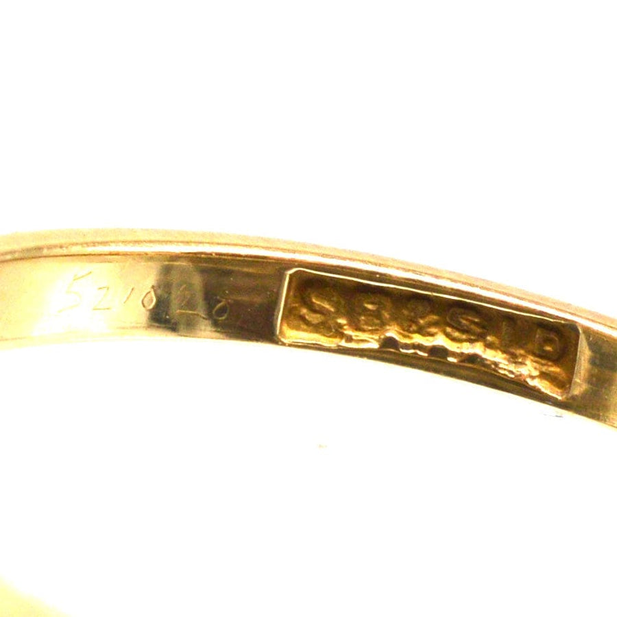 Close-up of an 18ct gold stamp inside a ring band showcasing craftsmanship and quality.