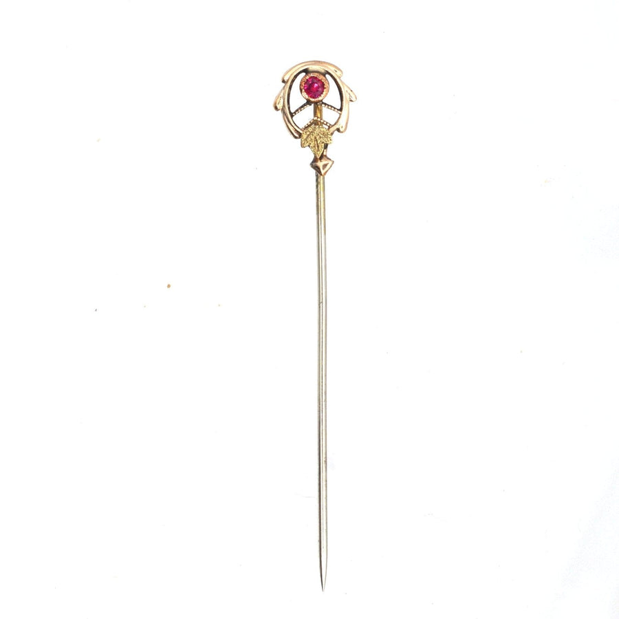Art Nouveau 9ct two color gold tie pin featuring stylised gold leaves and a ruby in millegrain setting.