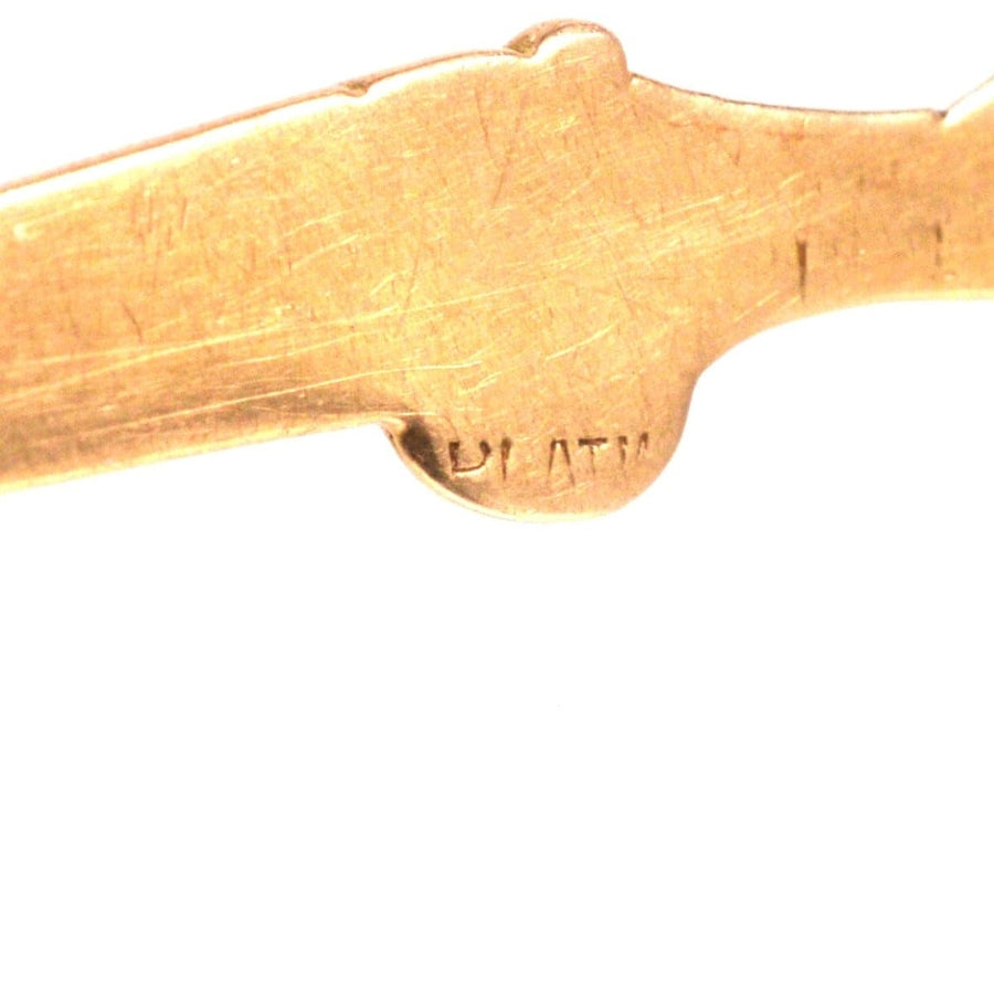 Close-up of the stamp engraving on a vintage 15ct gold and platinum grouse and shotgun brooch.
