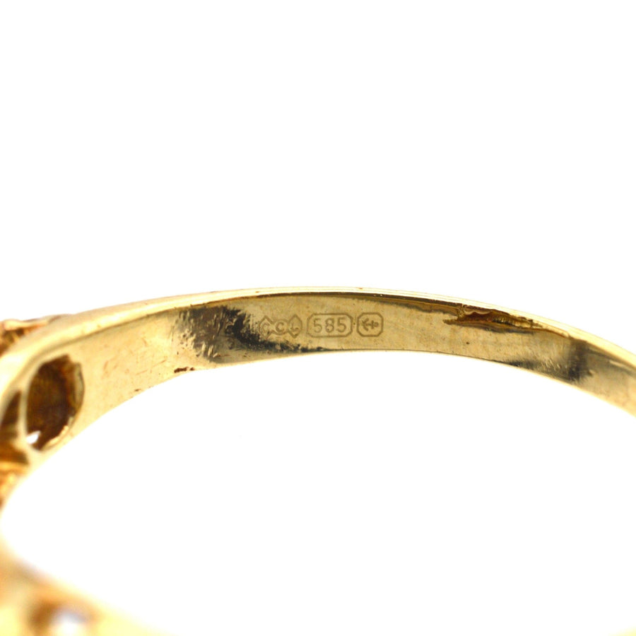 Close-up of the inside of an Edwardian gold ring, showing stamp and quality stamp for 15ct gold.