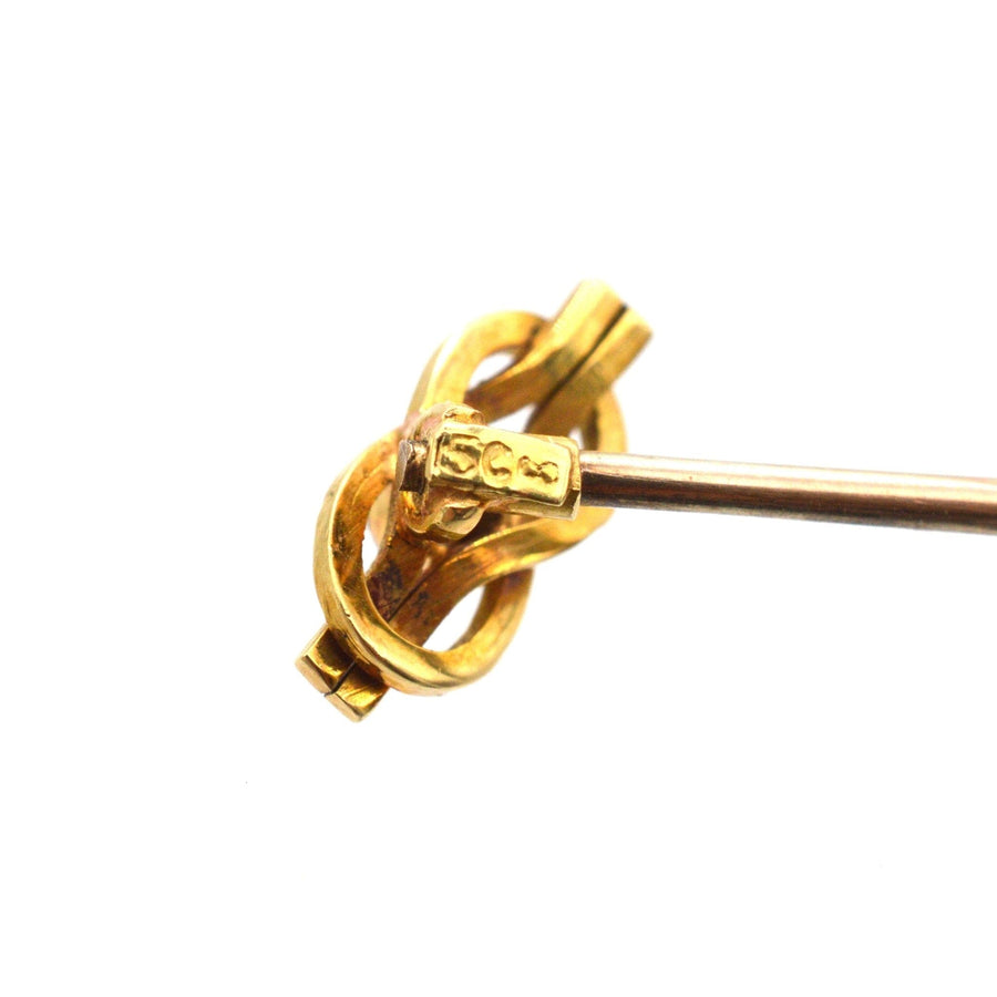 15ct gold reef knot tie pin with diamond, symbolizing love, crafted circa 1900, featuring intricate design and stamp.