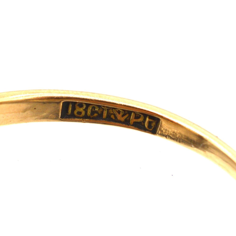 Close-up of the stamp showing 18ct gold and platinum certification on a vintage ring.