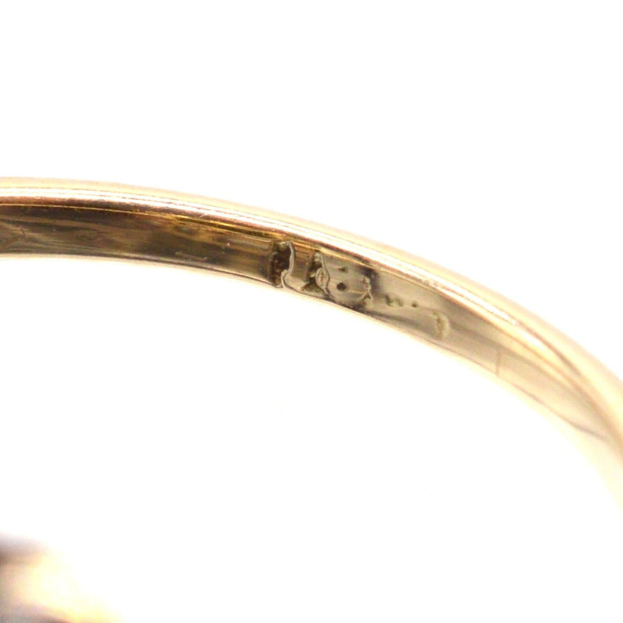 Close-up view of the stamp inside an Edwardian 18ct gold and platinum cluster ring.