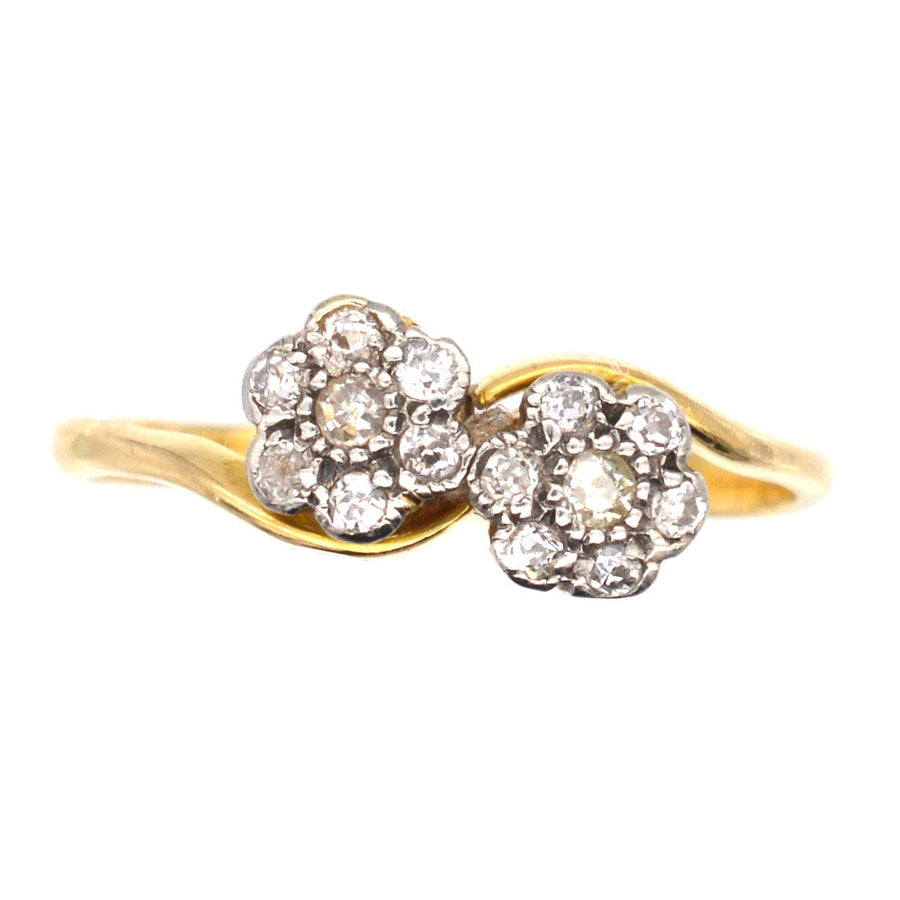 Edwardian 18ct gold double diamond cluster crossover ring with floral design and sparkling diamonds.