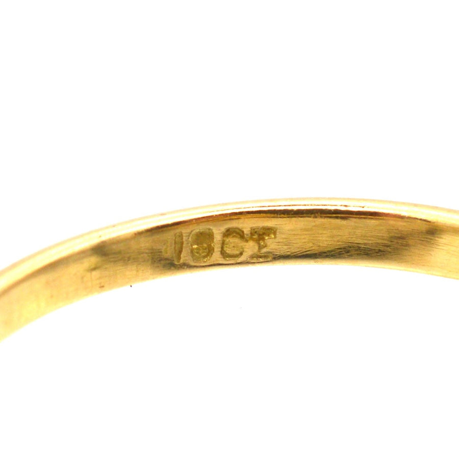 Close-up of a 18ct gold stamp on a vintage ring, showcasing its quality and craftsmanship.
