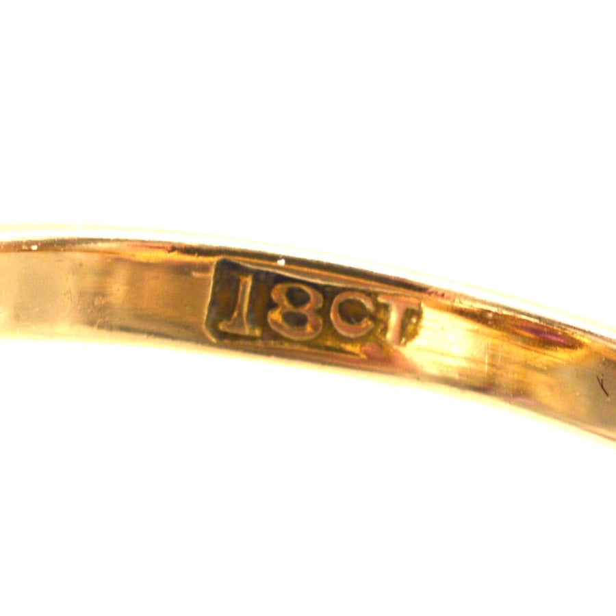 Close-up of the stamp on an 18ct gold ring, indicating purity and quality of the material.