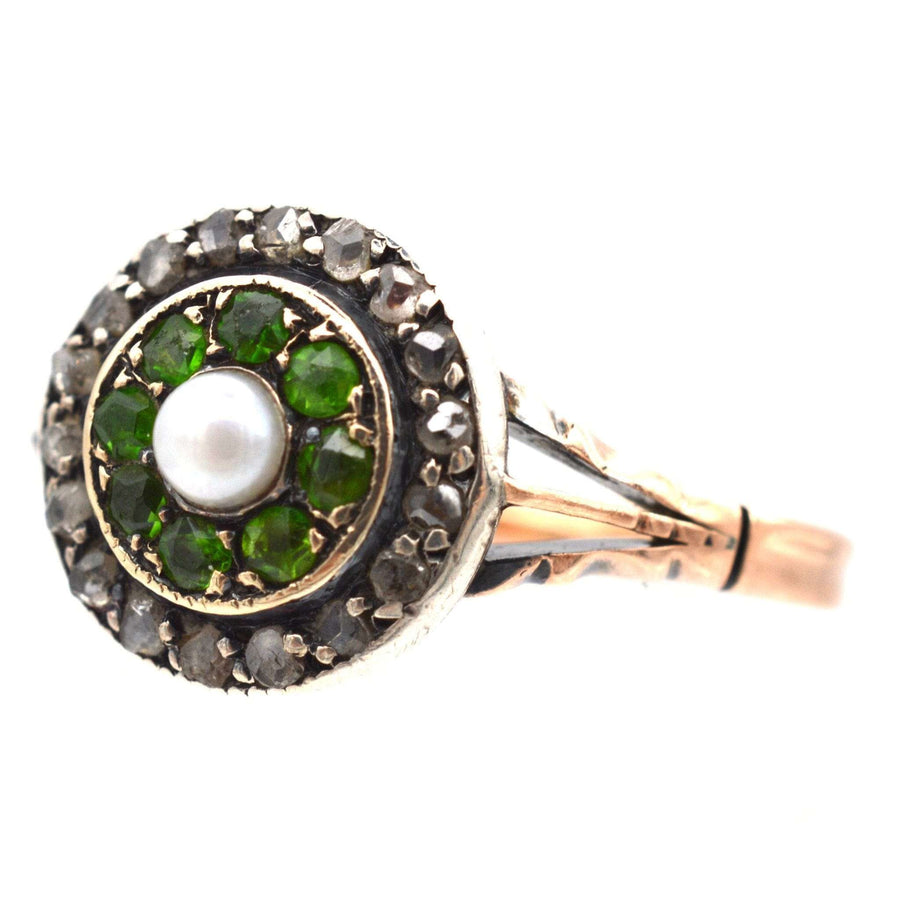 Edwardian 9ct gold target ring with green garnets, diamond embellishments, and a central natural pearl.