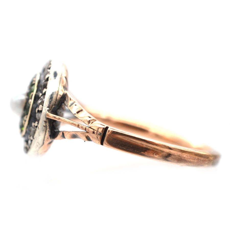 Edwardian 9ct gold target ring featuring green garnets, diamond accents, and a central pearl, showcasing antique craftsmanship.