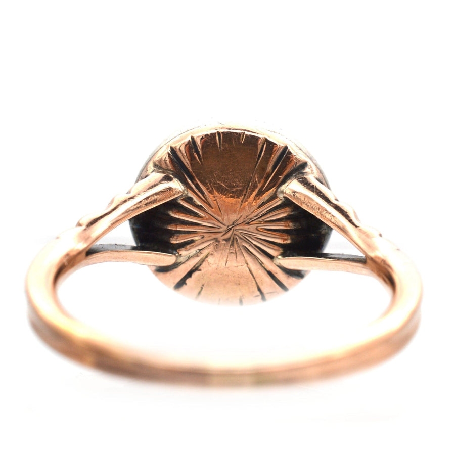 View of the back of an Edwardian 9ct gold target ring with intricate detailing and a smooth band.