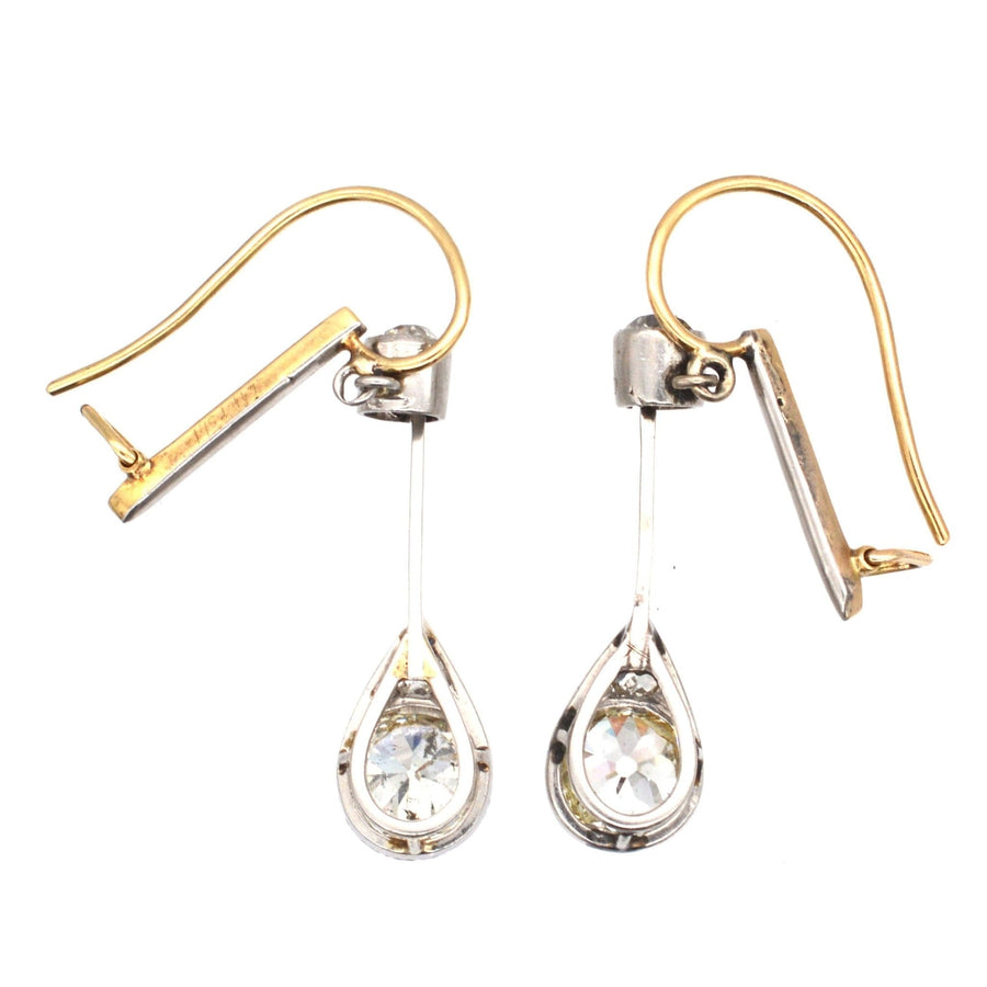 Edwardian platinum and 18ct gold diamond drop earrings featuring pear-shaped old cut diamonds.