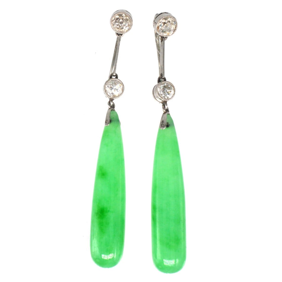 Edwardian platinum earrings featuring natural jade drops and diamonds in a vintage design.