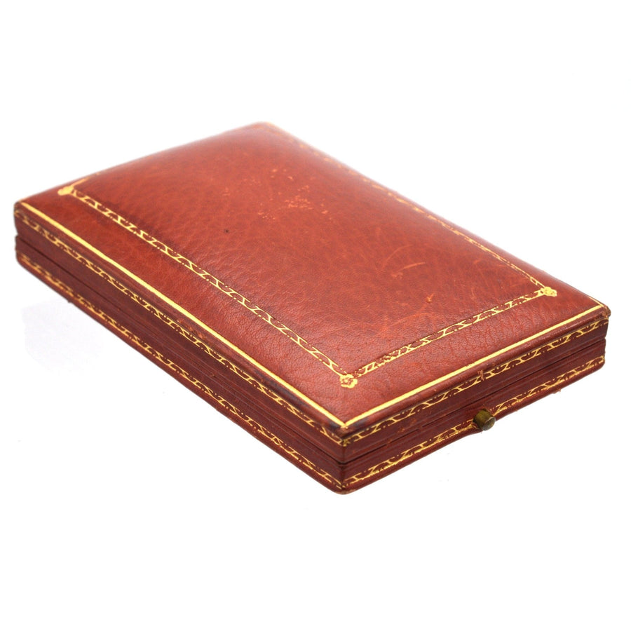 Vintage leather jewelry box featuring intricate gold detailing and a classic design.