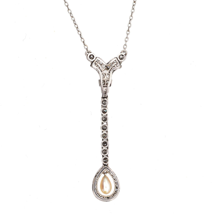 Edwardian pendant featuring a diamond-encircled natural pearl, on a platinum chain, showcasing exquisite craftsmanship.