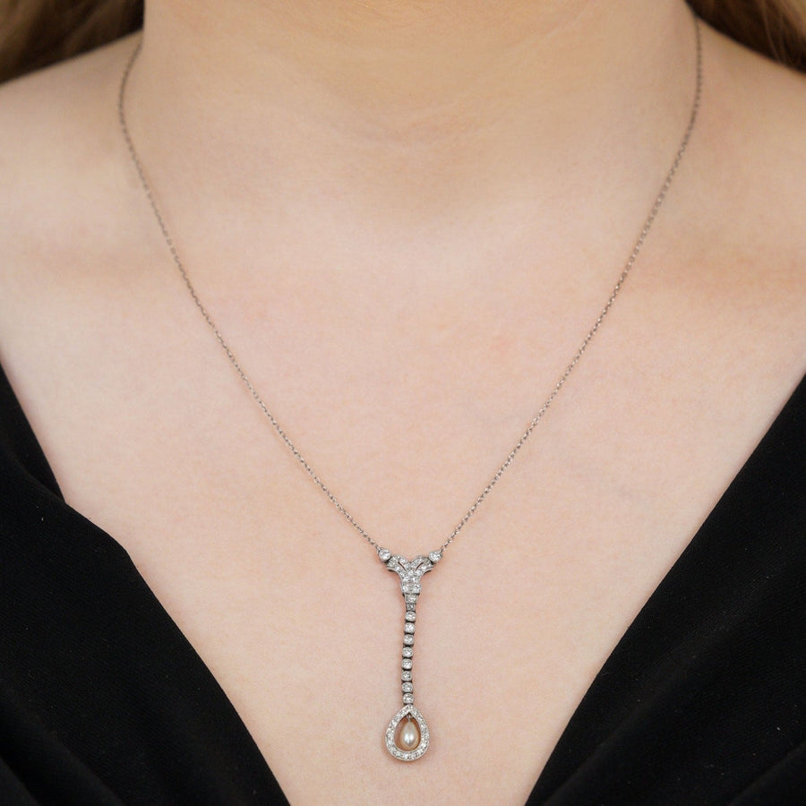Edwardian platinum diamond and natural pearl drop pendant on a delicate platinum chain, showcasing exquisite craftsmanship.
