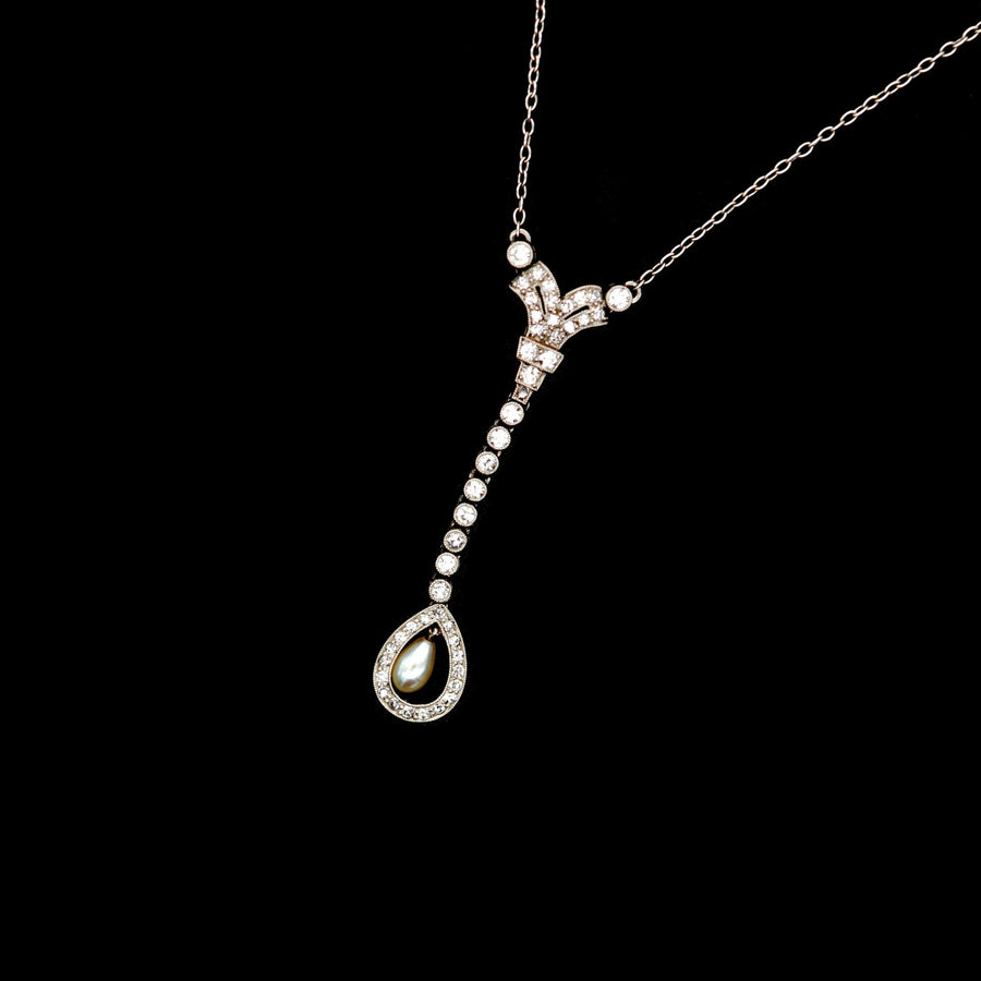 Edwardian platinum pendant with diamond and natural pearl drop on platinum chain, showcasing exquisite craftsmanship.