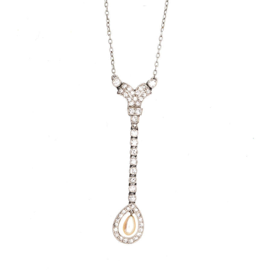Edwardian platinum pendant with diamond and pearl drop, featuring exquisite design and craftsmanship.