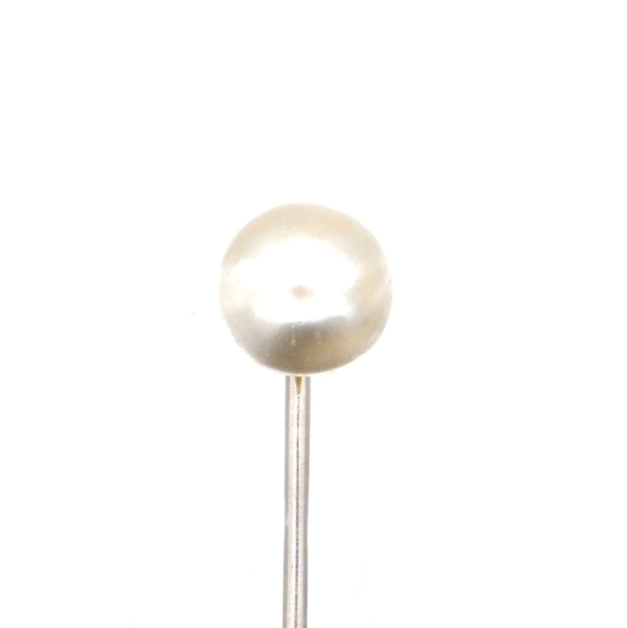 Edwardian platinum and natural pearl tie pin featuring a lustrous pearl atop a sleek platinum stickpin