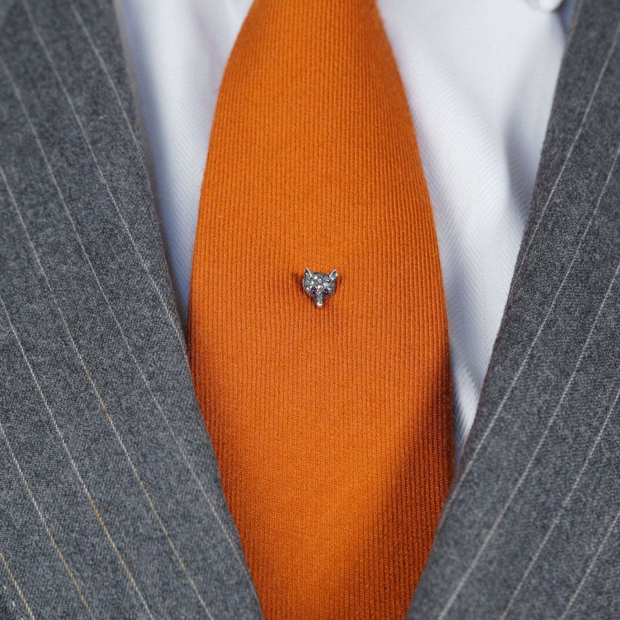 Edwardian rose diamond fox head tie pin with ruby eyes on an orange tie, perfect for country sports enthusiasts.
