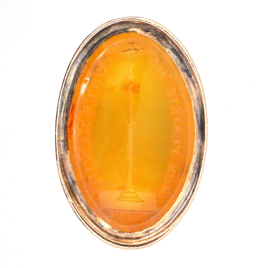 Georgian 9ct gold carnelian seal featuring an intaglio of a candle and moth symbolizing attraction.