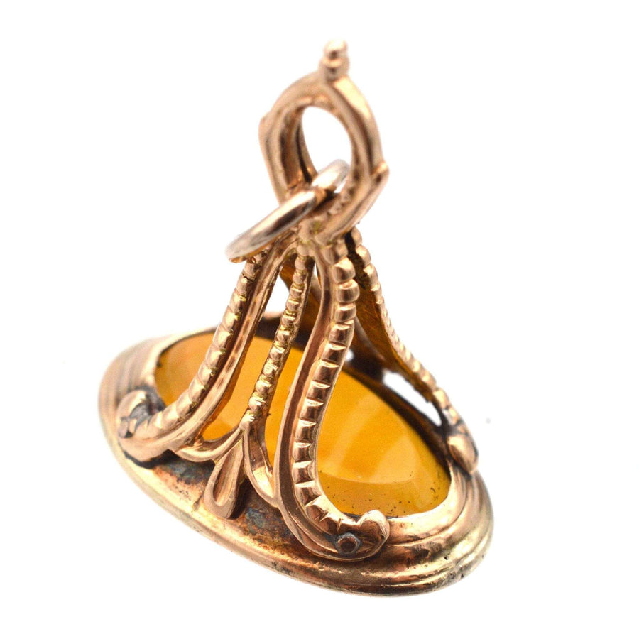 Georgian 9ct gold carnelian seal with intricate design featuring a moth and flame engraving.
