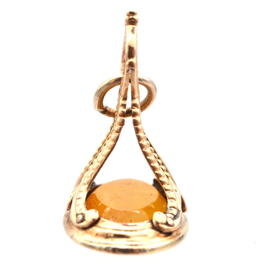Georgian 9ct gold carnalian seal pendant featuring an engraved moth and flame design.
