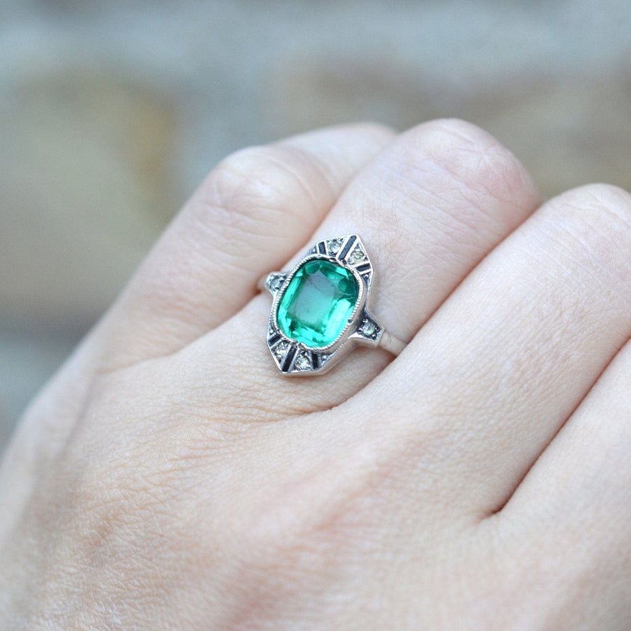 German Art Deco silver cocktail ring featuring emerald green paste and diamond paste accents.