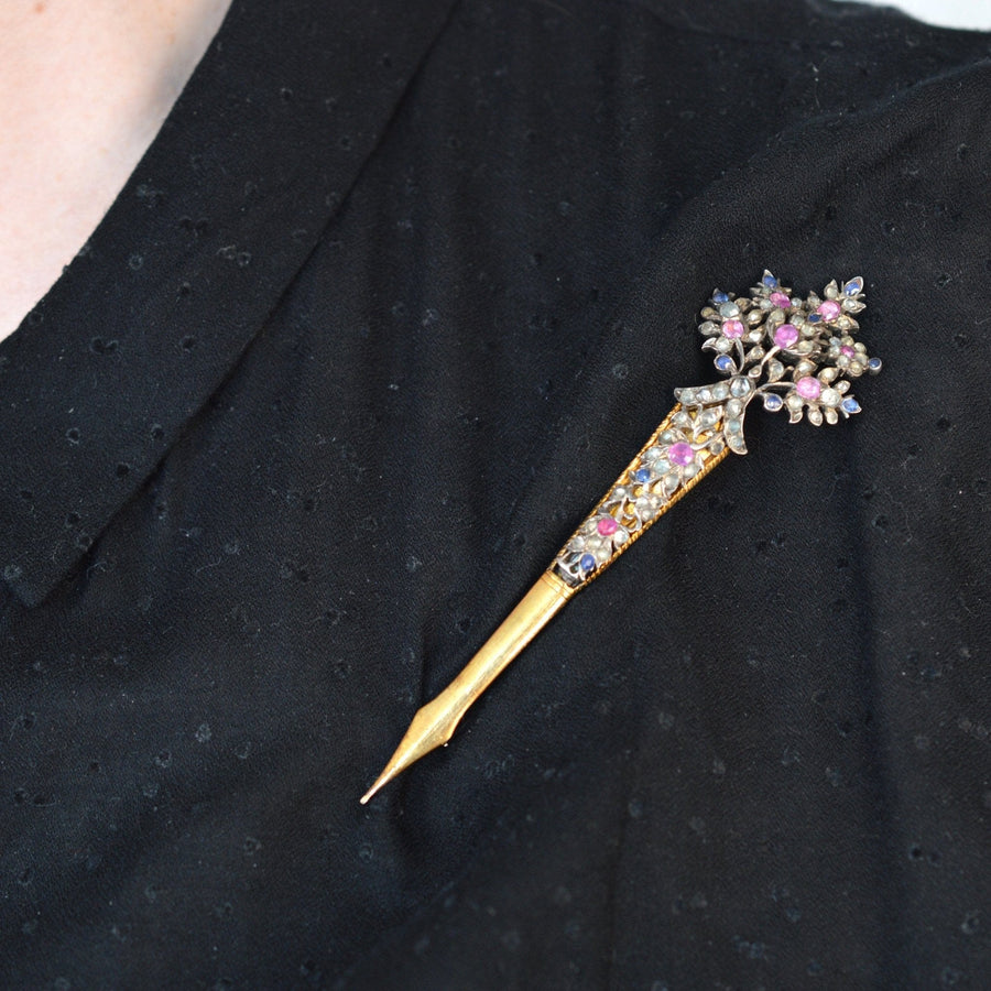 Late 19th century Sri Lankan gold kondakoora hairpin with sapphires and zircons, worn as a brooch.