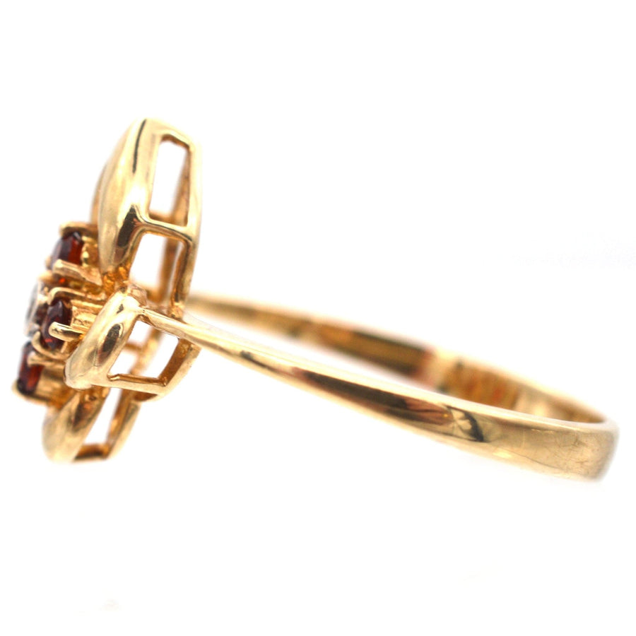 Late 20th Century 18ct gold ring featuring hessonite garnets and diamonds, highlighted by unique design elements.