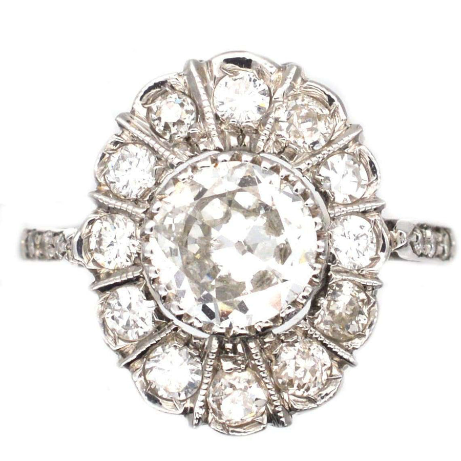 Mid Century 18ct white gold oval diamond cluster ring with 1 carat center diamond, circa 1960. Elegant engagement ring.