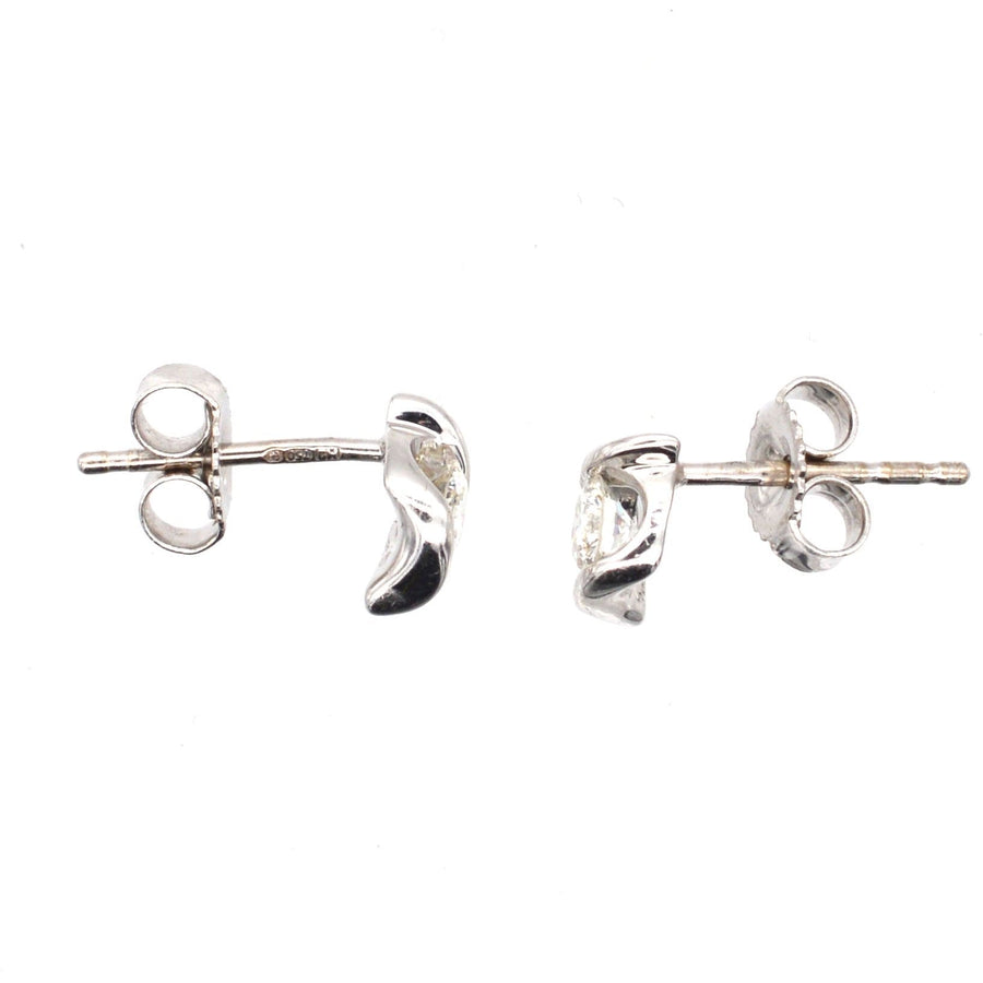 Modern 18ct white gold diamond stud earrings with twist detail, perfect for day-to-night wear.