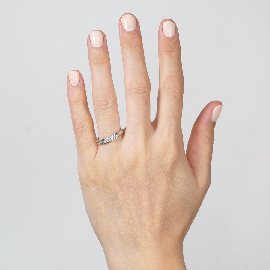Elegant 9ct white gold diamond half eternity ring showcased on a hand with neutral nail polish.