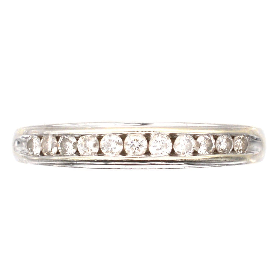9ct white gold diamond half eternity ring with 0.25 carats of brilliant cut diamonds in a channel setting.