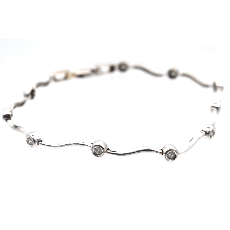 Modern 9ct white gold bracelet with wavy design and sparkling diamonds, elegant gift for young women.