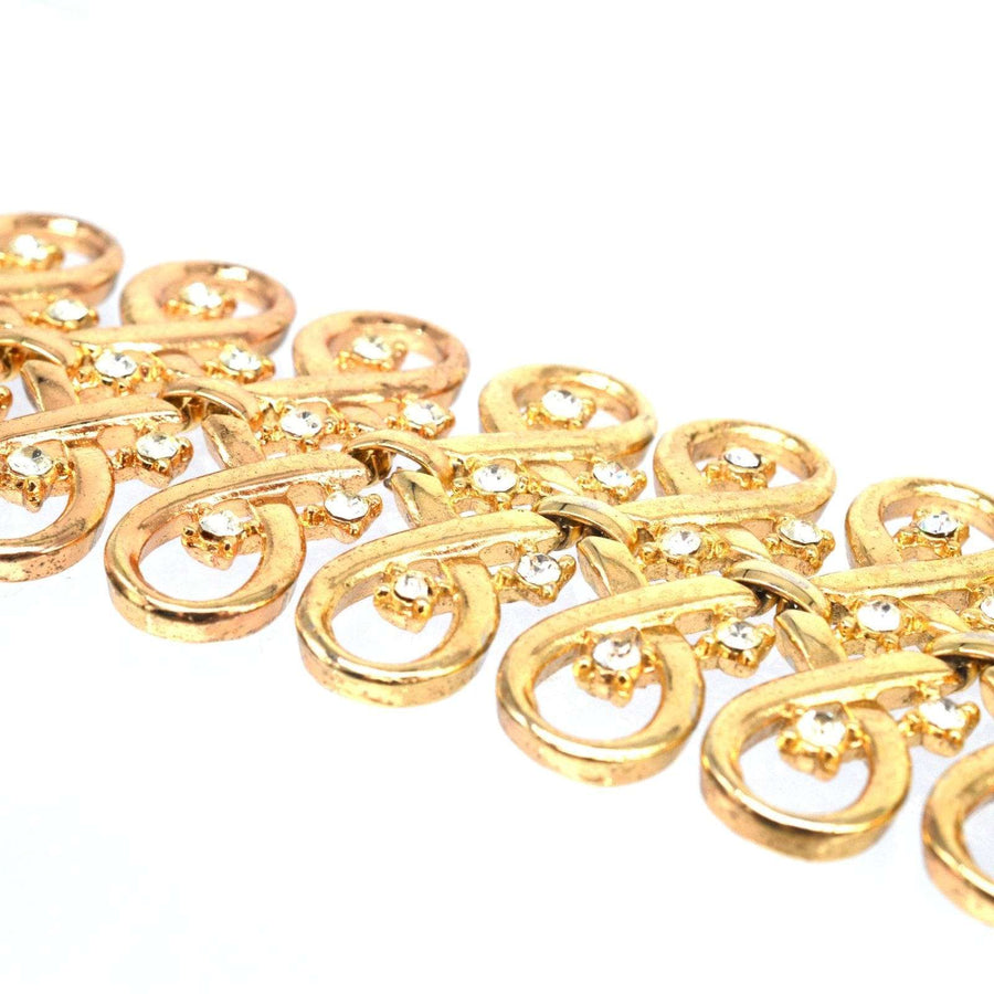 Trifari gold-tone paste bracelet featuring interlinked swirls and sparkling 'diamond' pastes, vintage jewelry.